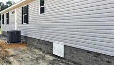 an air conditioner is on the side of a house that's being built