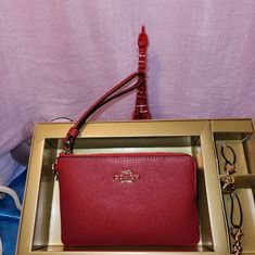 Coach Red Wrislet With Two Charms. New In Gift Box. Retail Value $ 128. Elegant Red Travel Pouch, Coach Pouch Clutch Gift, Coach Clutch Gift Pouch, Coach Pouch Clutch As Gift, Red Coach Clutch For Gift, Red Coach Clutch As A Gift, Elegant Red Coach Wallet, Elegant Coach Zipper Pouch, Chic Red Coach Wallet