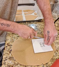 a man is making pizza dough with the words forever on his left hand and another person holding a knife in their other hand