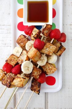 grilled tofu skewers with strawberries and bananas on a white plate