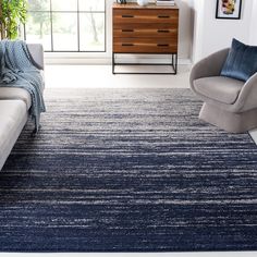 a living room filled with furniture and a blue rug