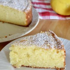 a piece of cake sitting on top of a white plate next to a slice of lemon cake