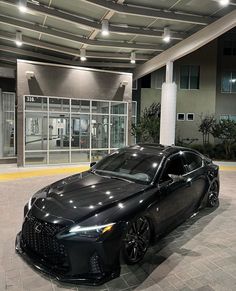 a black sports car parked in front of a building