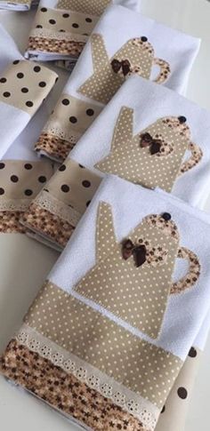 four folded napkins with brown and white polka dots on them are sitting on a table