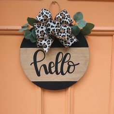 a hello sign with leopard print bows on it