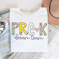 Pre-K Teacher Shirt, Pre-K Dream Team Tshirt, Pre-K Squad, Preschool Crew, PreK Teacher Shirt, Pre-K Teacher Team Shirts, Retro PreK Teacher ABOUT: ⋒ The shirt used is the Bella + Canvas 3001 Unisex Jersey Short Sleeve Tee ⋒ SOLID COLORS: 100% ring-spun cotton HEATHER COLORS: 52% ring-spun cotton & 48% polyester (Athletic Heather & Black Heather are 90% ring-spun cotton & 10 polyester) ⋒ Lightweight fabric - breathable ⋒ Rolled sleeves in pictures is for styling purposes only ⋒ Props used in pho Teacher Team Shirts Prek, Teacher Shirts Elementary, Prek Teacher Shirt, Pre K Shirts For Teachers, Winter Teacher Shirts, Prek Teacher Shirts Designs, White Tops For Teacher Appreciation Back To School, White School Top With Name Print, White Top With Name Print For Back To School