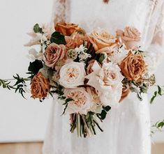 a bride holding a bouquet of flowers in her hands