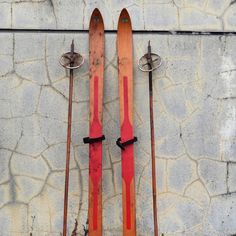 two skis are propped up against a wall