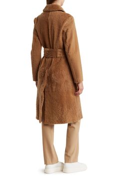 A statement piece for the winter season, this single-breasted, belted coat features soft and fuzzy genuine lamb shearling in a versatile hue. 43" length (size Small) Front button closure Spread collar Removable tie belt 100% genuine lamb shearling (Turkey) with leather lining Professional fur clean Imported Model stats: 5'10" height, 32" bust, 25" waist, 36" hip. Model is wearing size Small. Belted Coat, Shearling Coat, Tie Belt, Winter Season, The Winter, Single Breasted, Nordstrom Rack, Nordstrom, Size Medium