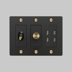 the black and gold switch plate has two different knobs on each side, one with three