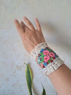 Linen detachable cuff bracelet with Embroidery are an extraordinary accessory that adds elegance to your casual clothes and turn them into haute looks and burst into your linen paradise. This beautiful unique Design linen fabric bracelet is made with embroidered  pink flowers with finishing lace and beads . Button closure. This cuff can be worn like real bracelet. The whole composition has a Boho Chic Style- elegant air and can be the piece of resistance for any outfit. You can wear them like on Bohemian Cuff Bracelet For Spring, Spring Bohemian Cuff Bracelet, Adjustable Hand-stitched Cuff Bracelet, Bohemian Cuff Bracelets For Spring, Spring Adjustable Bohemian Cuff Bracelet, Handmade Bracelets For Spring Festival, Bohemian Embroidered Bracelets For Weddings, Bohemian Embroidered Bangle Bracelets, Embroidered Multicolor Bracelets For Weddings