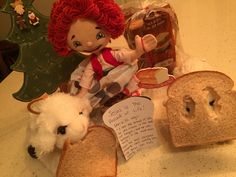 there is a stuffed doll next to two pieces of bread