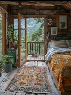 a bedroom with wooden walls and flooring has a large rug on the floor next to the bed