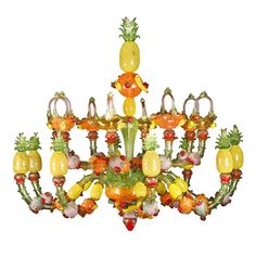 a chandelier made out of glass fruit and pineapples on it's sides