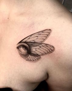 a close up of a person's chest with a butterfly tattoo on it