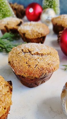 some muffins are sitting on a table next to christmas decorations