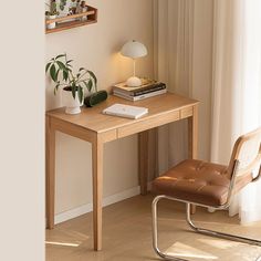 a small wooden desk with a chair next to it and some books on the shelf