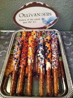 there are many different types of doughnuts in the tray on the table and one is decorated with sprinkles