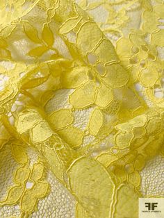 yellow lace fabric with flowers on it