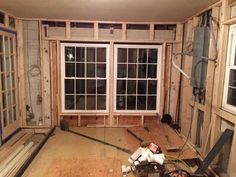 the room is being remodeled and ready to be used as a living area with windows