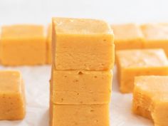 several pieces of yellow cake sitting on top of white paper