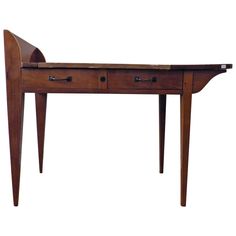 a wooden desk with two drawers on one side and an open drawer on the other