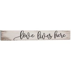 a sign that says love lives here on the side of a white wooden plank with black writing