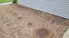 several stepping stones are on the ground in front of a house