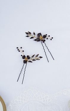 "These black and gold flower hairpins are a delightful addition to any hairstyle and are perfect for various occasions. This listing includes a set of TWO pins. Key Features: - Adorned with hand-sculpted wire flowers and leaves, embellished with beads - Designed to be lightweight, ensuring comfortable wear. - Finished with a durable glossy finish and gold trim for a metallic effect and durability. Approximate Dimensions (including pin): Width: 3 inches Height: 3.5 inches ------------------------------------------------- Please keep in mind before purchasing this product is \"MADE TO ORDER\" and has a production time of  1 - 2 weeks + shipping time to your area Due to the handmade nature of this product each headpiece is truly unique and special in its own way and may have slight variations Gold Bridal Crowns, Floral Bridal Hair, Floral Wedding Hair, Flower Hair Pins, Hair Accessories Set, Wire Flowers, Wedding Hair Pins, Flower Hair Pin, Bridal Hair Pins