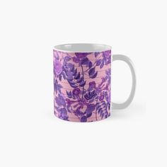 a pink and purple floral pattern on a coffee mug