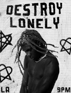 a man with dreadlocks standing in front of a sign that says destroy lonely