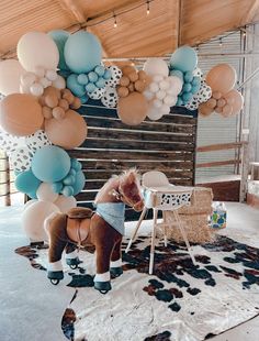 a horse is standing in front of some balloons