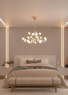 a large bed sitting under a chandelier next to a night stand with lights on it