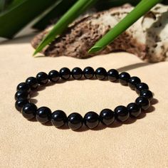 Experience the transformative benefits of our Black Obsidian crystal bracelet - a stylish source of confidence, power, and success! Crafted with attention, each bead is chosen to boost confidence, harness personal power, and pave the way for success. Our bracelet stands out for its superior quality, providing not just a chic accessory but a profound well-being experience. This commanding Black Obsidian bracelet is perfect for treating yourself or as a thoughtful gift for a loved one on any occas Elegant Obsidian Bracelets For Meditation, Black Crystal Gemstone Bracelet For Meditation, Black Gemstone Beaded Bracelets For Meditation, Bracelet Stands, Black Obsidian Bracelet, Crystals Black, Obsidian Crystal, Obsidian Bracelet, Boost Confidence