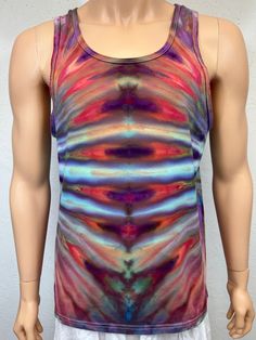 Ice tie dye men's medium sized tank. This tank is 100% cotton and is machine wash and dry with dark colors. Great for summer festivals and concerts! Fun psychedelic pattern on front and back. Measurements are garment laid out flat  20 inches from armpit to armpit across the front  20 1/2 inches from center of top hem to bottom hem down center front 11 inches from top of arm hole to bottom at armpit Summer Cotton Racerback Vest, Hippie Multicolor Tank Top For Festival, Multicolor Vest Tank Top For Festival, Hippie Cotton Tank Top, Cotton Tank Top For Spring Music Festival, Racerback Tank Top For Summer Music Festival, Summer Music Festival Racerback Tank Top, Cotton Tank Top For Summer Music Festival, Sleeveless Tank Top For Summer Music Festival