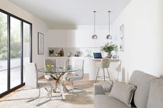 a living room filled with furniture and a glass table