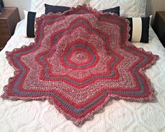 a crocheted blanket on top of a bed