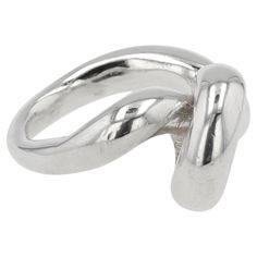 The Sterling Silver Mangala Curl Ring by Ariana Boussard-Reifel is a striking piece that elegantly wraps around the finger with fluid, curling lines. This ring captures modern sophistication and timeless beauty, making it a versatile addition to any jewelry collection. A scribbling spiral that creates an artistic gesture across the finger. The coil is thick and substantial, giving the wearer a soothing feel. It is available in size 7 and can be sized. Ariana Boussard-Reifel is a renowned jewelry designer who is celebrated for her bold, sculptural pieces inspired by global artifacts and ancient cultures. Her work merges traditional craftsmanship with contemporary design, resulting in unique, wearable art. Boussard-Reifel’s creations have garnered acclaim for their innovative forms and metic Modern Bangle, Modern Hoop Earrings, Twisted Bangle, Snake Ring Silver, Snake Design, Modern Ring, Sterling Silver Hoop Earrings, Ancient Cultures, Oxidized Sterling Silver