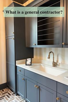 a bathroom with gray cabinets and white counter tops, which has the words what is a general contructor?