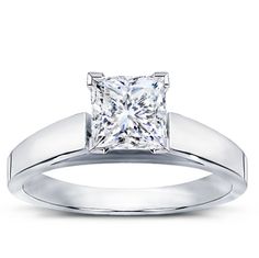 a princess cut diamond engagement ring set in 18k white gold with an invisible band