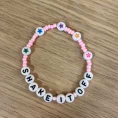 a pink and white beaded name bracelet