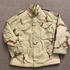 The Original Cold Weather Jacket For The Us Military. This One Is In The Classic 3-Color Desert Camouflage Pattern. This Jacket Is Almost Brand New With The Exception Of A Small Stain On The Front Near The Waist (See Last Picture). It Acts As A Great Layer For Cold Conditions As Either An Outer Layer Or A Mid Layer. The Jacket Has The Outer Nylon Layer For Protection And A Canvas Internal Layer For A Little Bit Of Insulation. The Jacket Has The Additional Ability To Button On A Fur Hood And A Bu Combat Outerwear With Cargo Pockets In Khaki, Combat Style Khaki Outerwear With Cargo Pockets, Tactical Khaki Outerwear With Cargo Pockets, Brown Hooded Military Outerwear, Army Jackets, Desert Camouflage, Brown Military Outerwear With Multiple Pockets, Cold Weather Jackets, Military Outerwear With Flap Pockets For Hunting