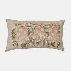 an embroidered pillow with three mushrooms on it