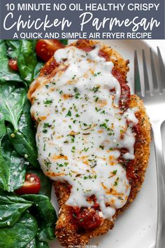 chicken parmesan on a plate with spinach leaves