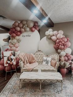 a living room with balloons and couches on the floor, in front of a wall