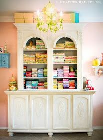 a white china cabinet filled with lots of books