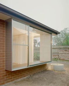 an open window on the side of a brick building