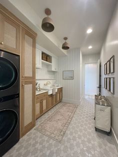 a kitchen with an oven, refrigerator and washer in the middle of it's room