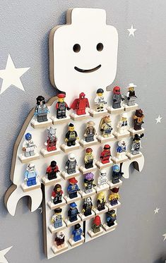 a wall mounted lego figure display on the side of a gray wall with white stars