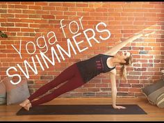 a woman doing yoga in front of a brick wall